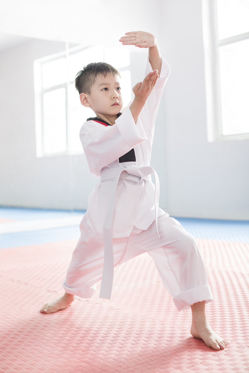 Cute Chinese boy practicing Tae Kwon Do