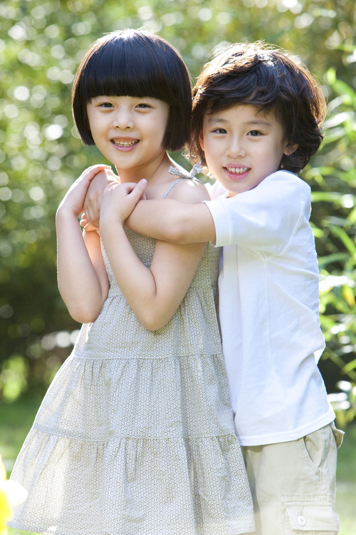 Cute Chinese children having fun in garden