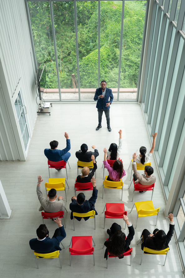 Top view of a group of business people sitting and listening to